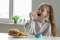 Ultra-processed food consumption has been shown to be prevalent among the young. Image Source: Getty Images/bymuratdeniz