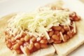 Data shows that 64% of consumers believe that cheese makes baked beans tastier. Image Source: Getty Images/Tornadoflight